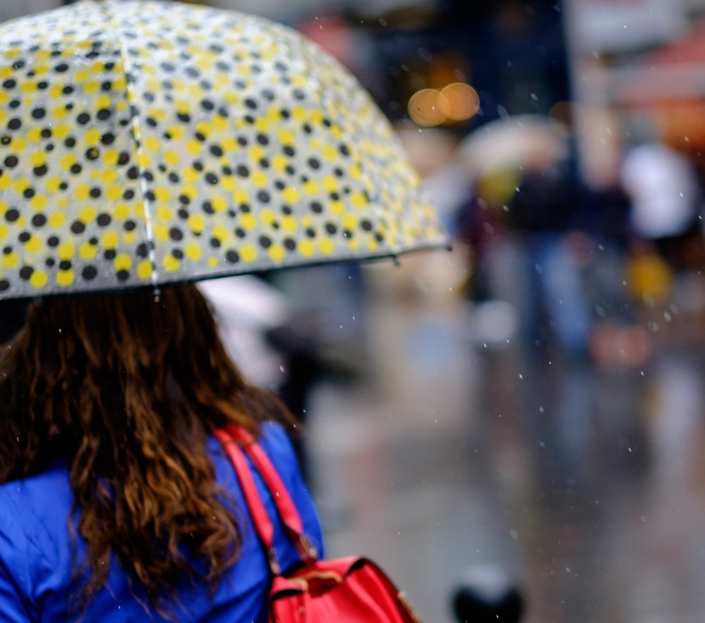 雨のなか通勤する女性